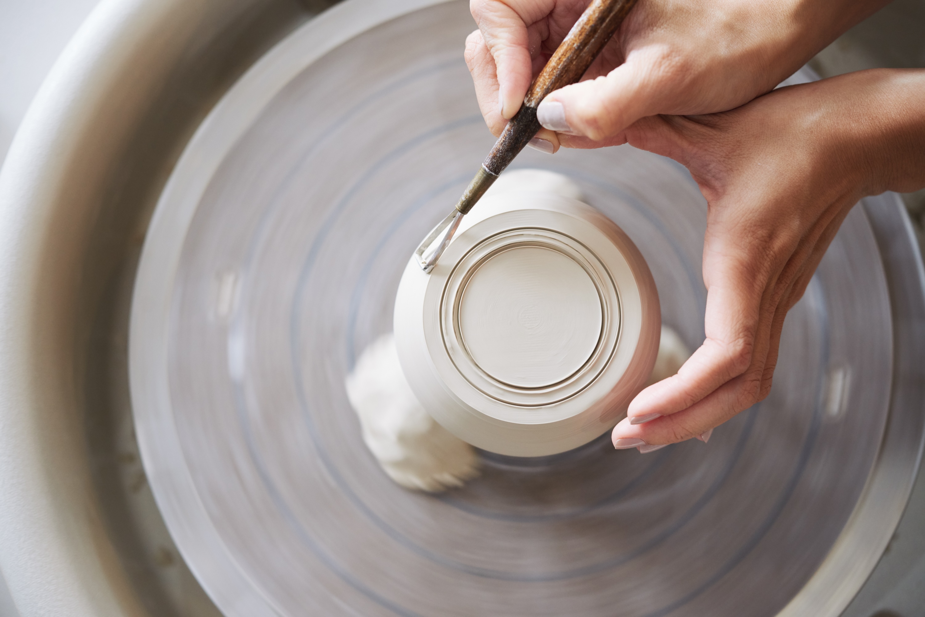 Carving a clay pot